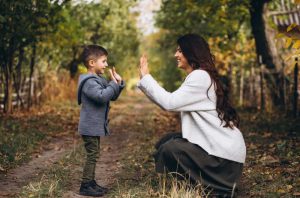 Mother with little son in an autumn park