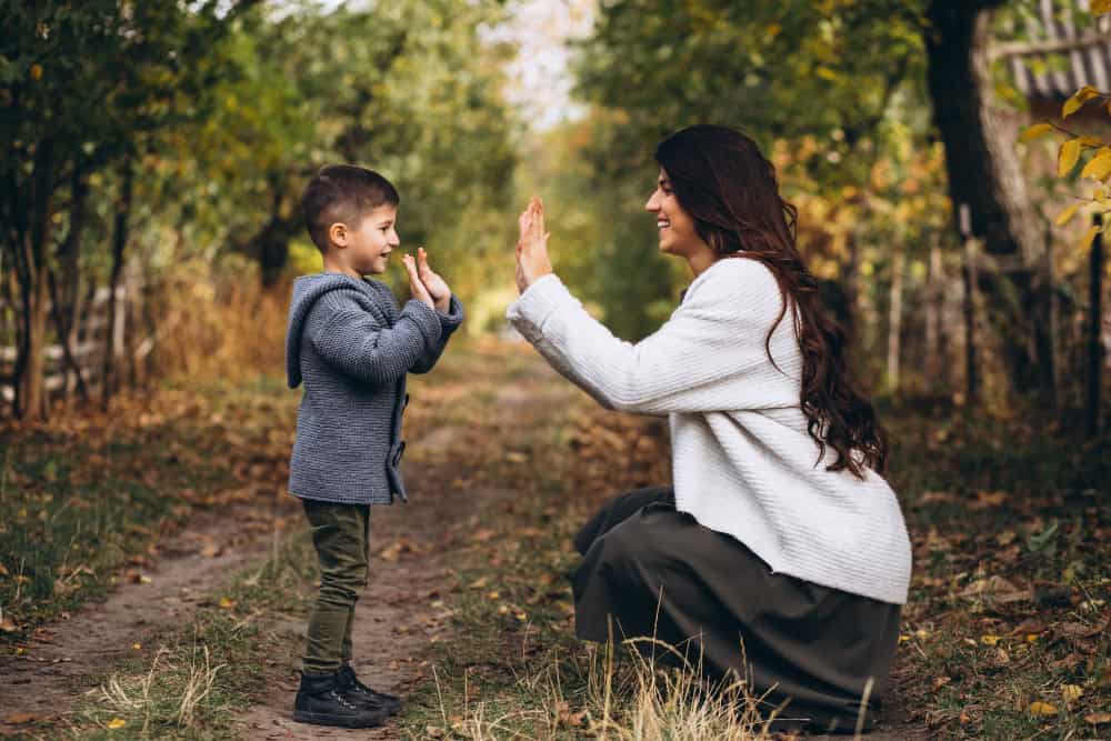Mother with little son in an autumn park